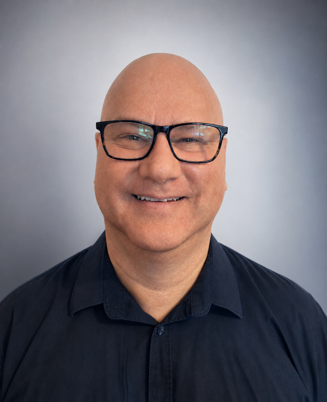 Stephen Simpson, founder of About Autism, smiling and wearing glasses